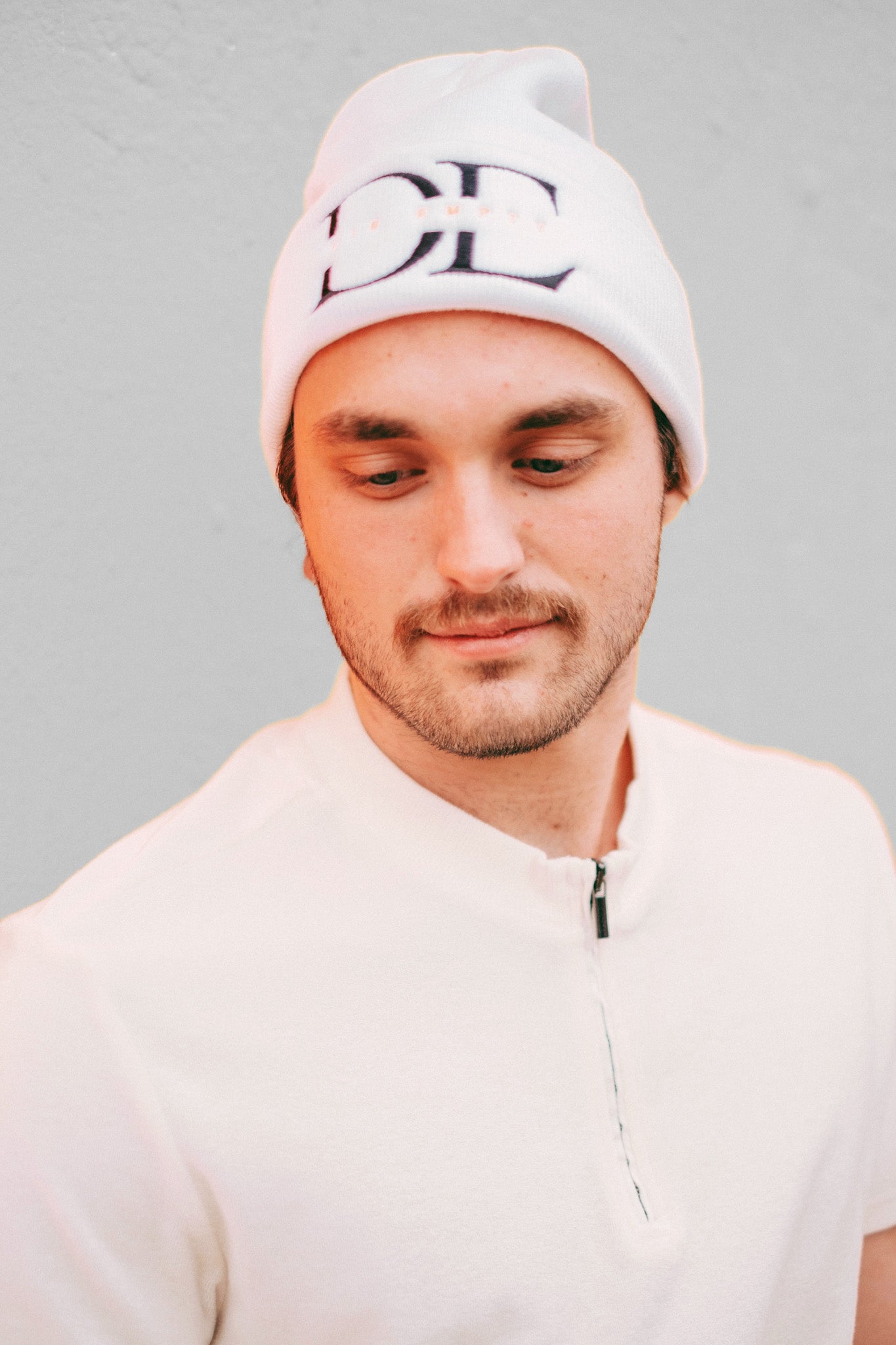 frontal image of White Die Empty Beanie on a caucasian male model taken from frontal angle